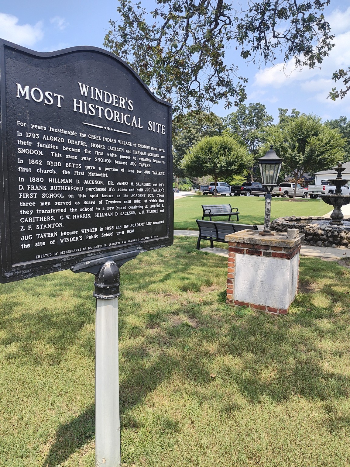 Winder's Most Historical Site marker identifying the former Snodon settlement site, with the park fountain visible to the right.